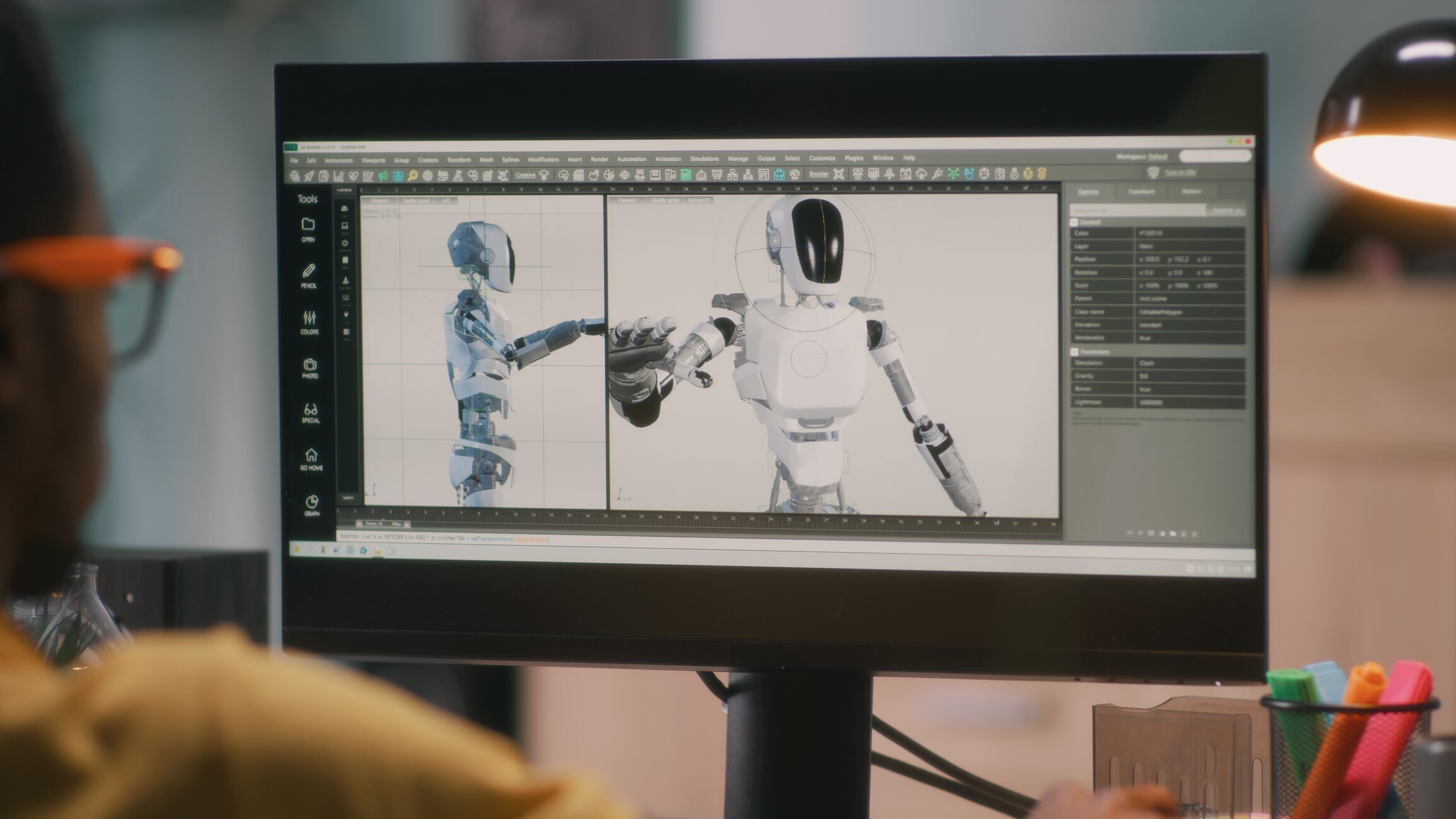 African American male creating 3D model of robot and rendering video for movie or computer game on computer while working from home