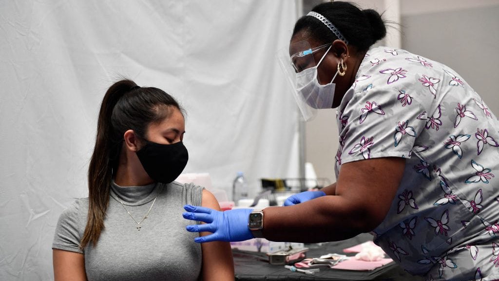 A nurse administers a dose of the Moderna Covid-19 vaccine at a clinic for Catholic school education workers including elementary school teachers and staff at a vaccination site at Loyola Marymount University (LMU) on March 8, 2021 in Los Angeles, California. (Photo by Patrick T. FALLON / AFP) (Photo by PATRICK T. FALLON/AFP via Getty Images)