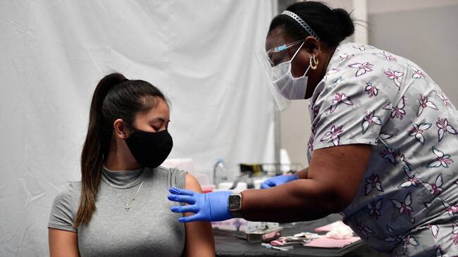 A nurse administers a dose of the Moderna Covid-19 vaccine at a clinic for Catholic school education workers including elementary school teachers and staff at a vaccination site at Loyola Marymount University (LMU) on March 8, 2021 in Los Angeles, California. (Photo by Patrick T. FALLON / AFP) (Photo by PATRICK T. FALLON/AFP via Getty Images)