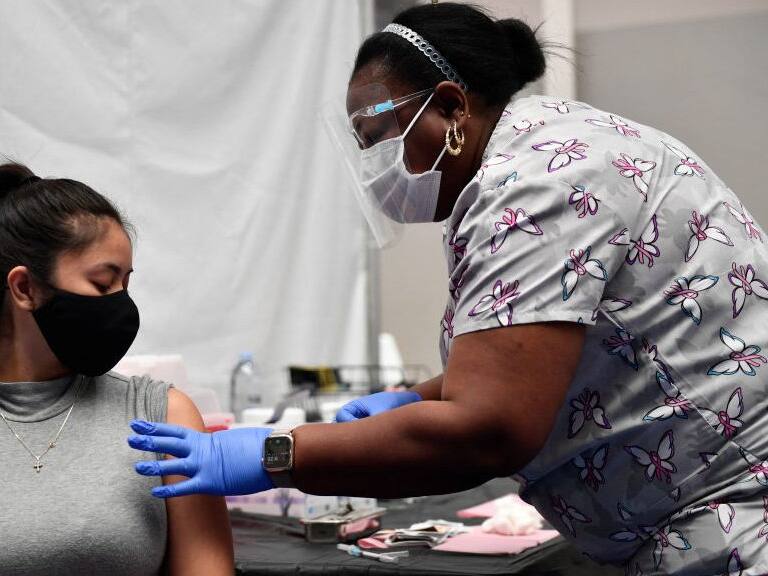 A nurse administers a dose of the Moderna Covid-19 vaccine at a clinic for Catholic school education workers including elementary school teachers and staff at a vaccination site at Loyola Marymount University (LMU) on March 8, 2021 in Los Angeles, California. (Photo by Patrick T. FALLON / AFP) (Photo by PATRICK T. FALLON/AFP via Getty Images)