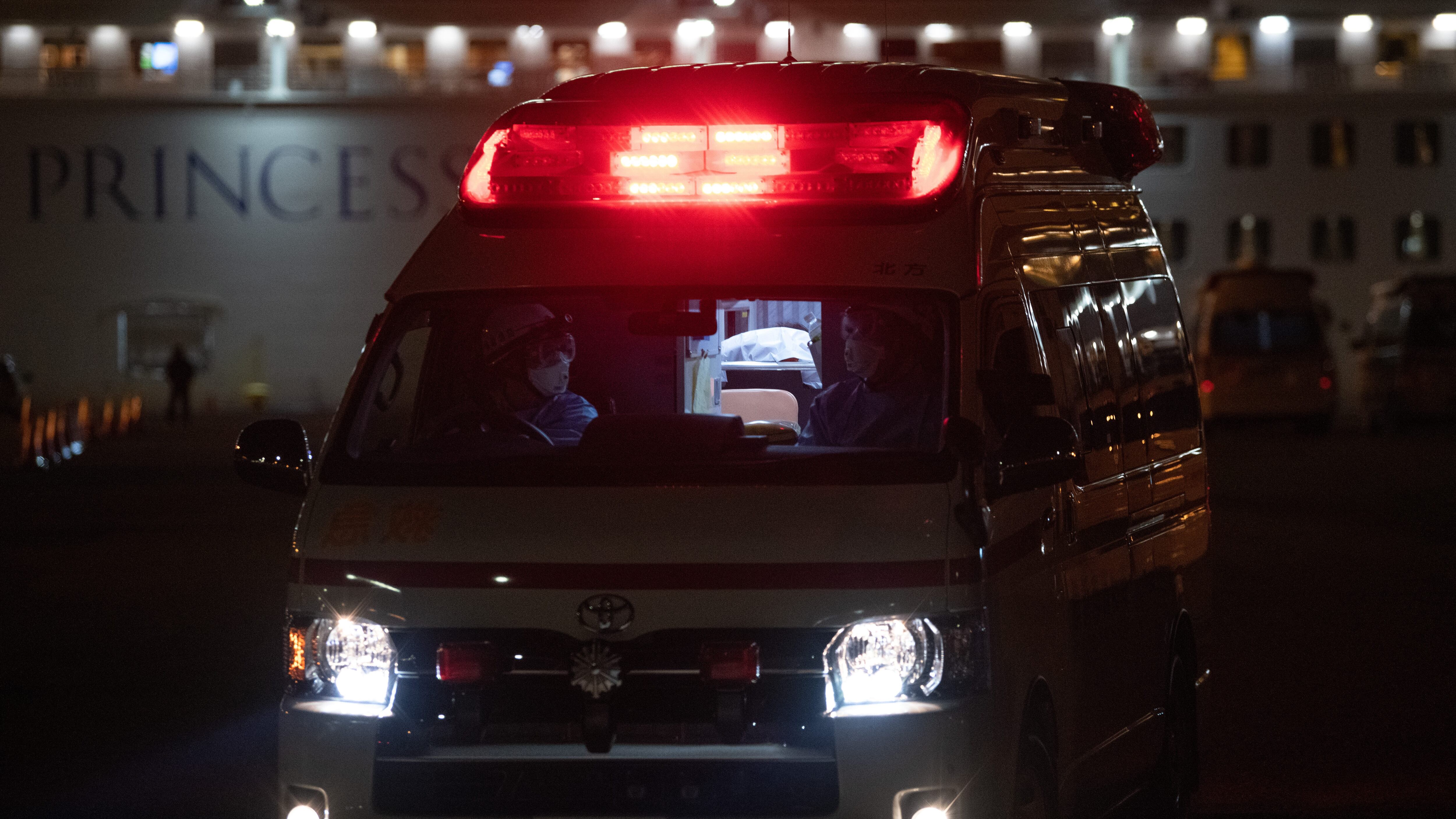 YOKOHAMA, JAPAN - FEBRUARY 10: An ambulance carries a passenger diagnosed with coronavirus from the Diamond Princess at Daikoku Pier where the ship is being resupplied and newly diagnosed coronavirus cases taken for treatment as it remains in quarantine after a number of the 3,700 people on board were diagnosed with coronavirus, on February 10, 2020 in Yokohama, Japan. 130 passengers are now confirmed to be infected with coronavirus as Japanese authorities continue treating people on board. The new cases bring the total number of infections to 156 in Japan, the largest number outside of China. (Photo by Carl Court/Getty Images)