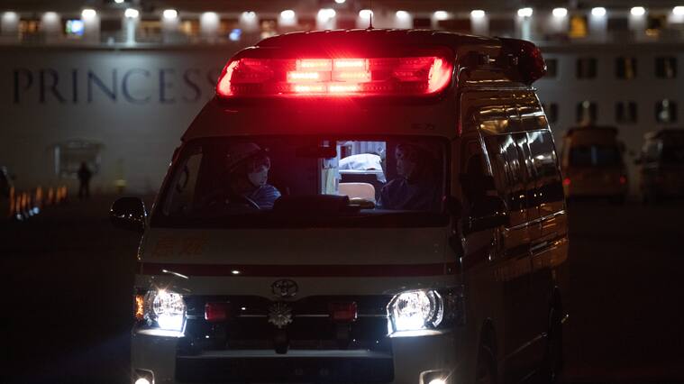 YOKOHAMA, JAPAN - FEBRUARY 10: An ambulance carries a passenger diagnosed with coronavirus from the Diamond Princess at Daikoku Pier where the ship is being resupplied and newly diagnosed coronavirus cases taken for treatment as it remains in quarantine after a number of the 3,700 people on board were diagnosed with coronavirus, on February 10, 2020 in Yokohama, Japan. 130 passengers are now confirmed to be infected with coronavirus as Japanese authorities continue treating people on board. The new cases bring the total number of infections to 156 in Japan, the largest number outside of China. (Photo by Carl Court/Getty Images)
