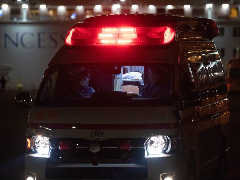 YOKOHAMA, JAPAN - FEBRUARY 10: An ambulance carries a passenger diagnosed with coronavirus from the Diamond Princess at Daikoku Pier where the ship is being resupplied and newly diagnosed coronavirus cases taken for treatment as it remains in quarantine after a number of the 3,700 people on board were diagnosed with coronavirus, on February 10, 2020 in Yokohama, Japan. 130 passengers are now confirmed to be infected with coronavirus as Japanese authorities continue treating people on board. The new cases bring the total number of infections to 156 in Japan, the largest number outside of China. (Photo by Carl Court/Getty Images)