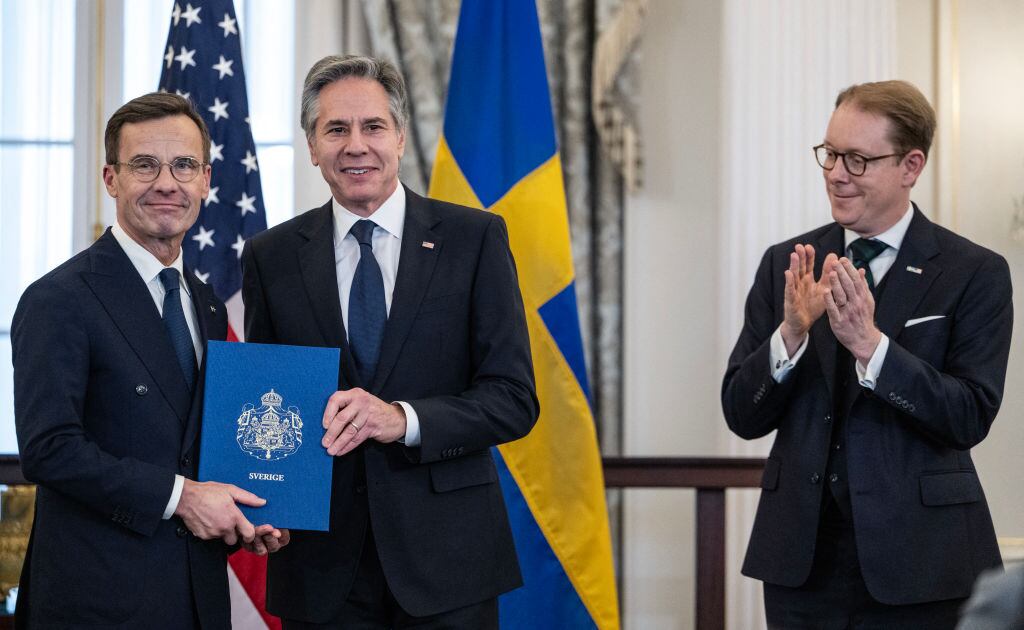 US Secretary of State Antony Blinken receives the NATO ratification documents from Swedish Prime Minister Ulf Kristersson, as Swedish Foreign Minister Tobias Billstrom applauds, during a ceremony at the US State Department, as Sweden formally joins the North Atlantic alliance, in Washington, DC, on March 7, 2024. Kristersson hailed his country's entry into NATO as a "victory for freedom," as it turned the page on two centuries of non-alignment following Russia's invasion of Ukraine. The accession "is a victory for freedom today. Sweden has made a free, democratic, sovereign and united choice to join NATO," he said at the ceremony. (Photo by ANDREW CABALLERO-REYNOLDS / AFP) (Photo by ANDREW CABALLERO-REYNOLDS/AFP via Getty Images)