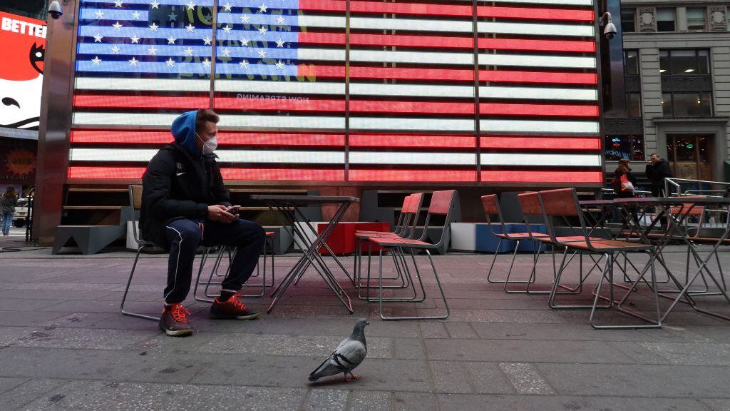 NEW YORK, NY - MARCH 12: A man wears a protective mask as he sits in Times Square on March 12, 2020 in New York City. (Photo by Gary Hershorn/Corbis via Getty Images)