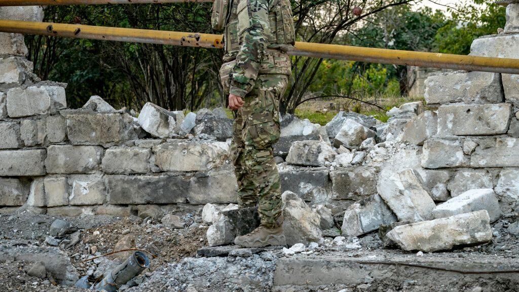 A soldier checks an azeri rocket nailed on the ground during the clashes between Azerbaijan and Nagorno Karabakh armies on October 9, 2020. (Photo by Celestino Arce/NurPhoto via Getty Images)