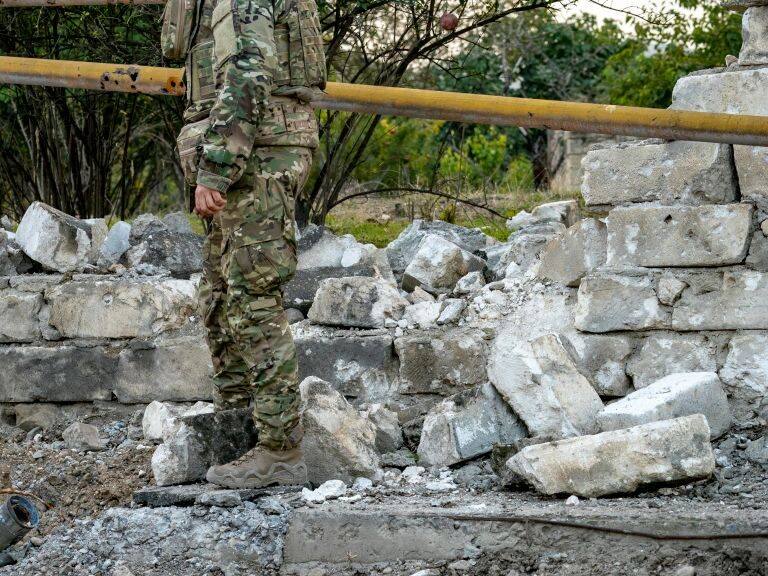 A soldier checks an azeri rocket nailed on the ground during the clashes between Azerbaijan and Nagorno Karabakh armies on October 9, 2020. (Photo by Celestino Arce/NurPhoto via Getty Images)