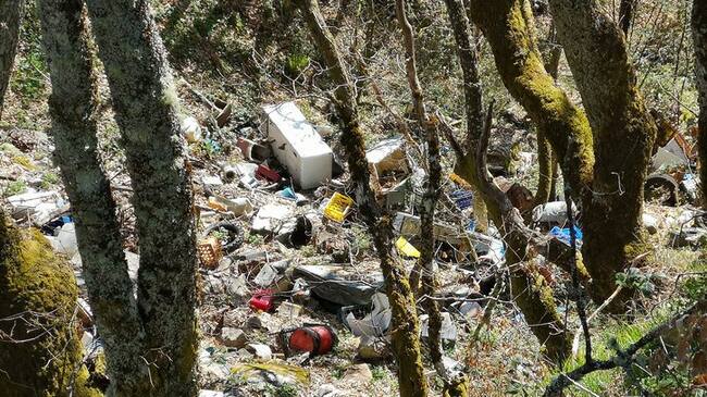 Illegal dumping ground for toxic waste in a natural area of oak forests in the Cantabrian Mountains (Palacios del Sil, León, Spain).