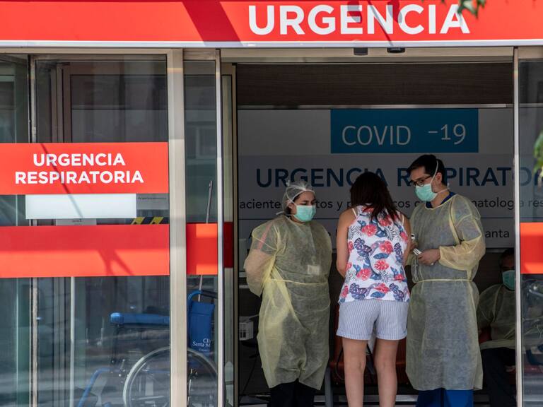 A woman requests information to doctors at the emergency room of a hospital in Santiago, on March 30, 2020. - More than 1.3 million people of seven of the main communes of Santiago were placed into total quarantine aiming to curb the spread of the novel coronavirus, COVID-19. (Photo by Martin BERNETTI / AFP) (Photo by MARTIN BERNETTI/AFP via Getty Images)