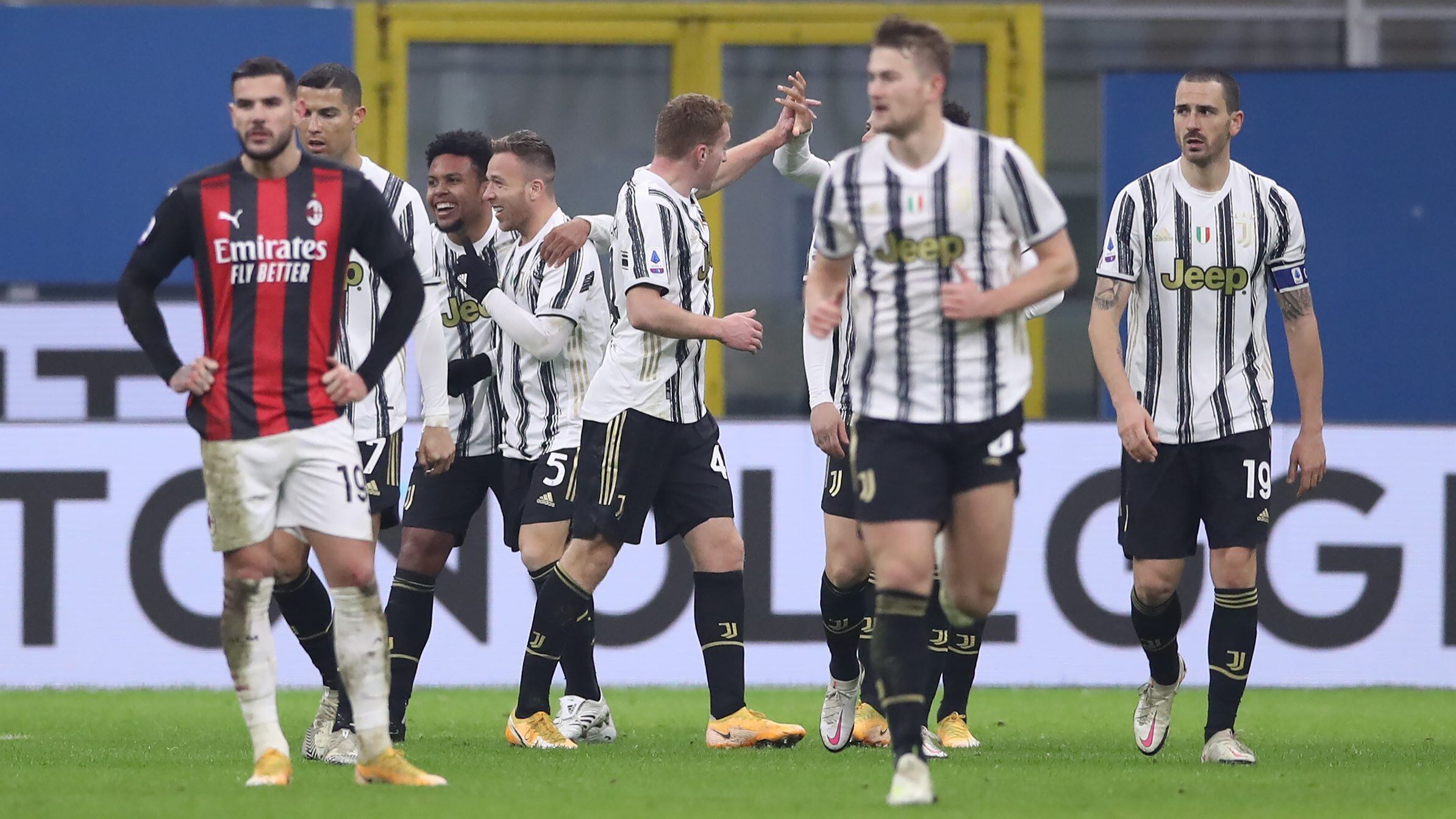 MILAN, ITALY - JANUARY 06: Theo Hernandez of AC Milan reacts in the foreground as Weston McKennie of Juventus celebrates a goal with his teammates during the Serie A match between AC Milan and Juventus at Stadio Giuseppe Meazza on January 06, 2021 in Milan, Italy. (Photo by Jonathan Moscrop/Getty Images)