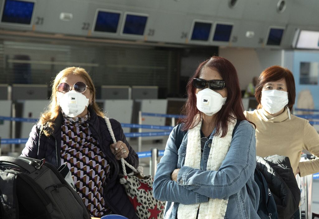 Un grupo de pasajeros con mascarilla en el Aeropuerto de Ezeiza en el Gran Buenos Aires