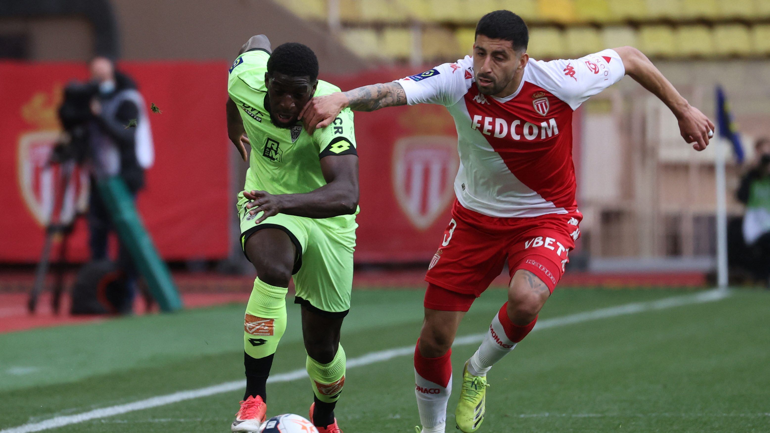 Monaco's Chilean defender Guillermo Maripan (R) fights for the ball with Dijon's Kamara Aboubakar (L) during the French L1 football match between AS Monaco and Dijon at "Louis II" stadium in Monaco, on April 11, 2021. (Photo by Valery HACHE / AFP) (Photo by VALERY HACHE/AFP via Getty Images)