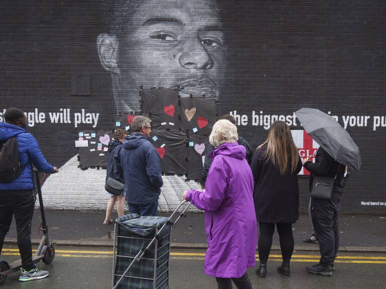 MANCHESTER, ENGLAND - JULY 12: Local residents put messages of support on the plastic that covers offensive graffiti on the vandalised mural of Manchester United striker and England player Marcus Rashford on the wall of a cafe on Copson Street, Withington on July 12, 2021 in Manchester, England. Rashford and other Black players on England's national football team have been the target of racist abuse, largely on social media, after the team's loss to Italy in the UEFA European Football Championship last night. England manager Gareth Southgate, Prime Minister Boris Johnson, and the Football Association have issued statements condemning the abuse. (Photo by Christopher Furlong/Getty Images)