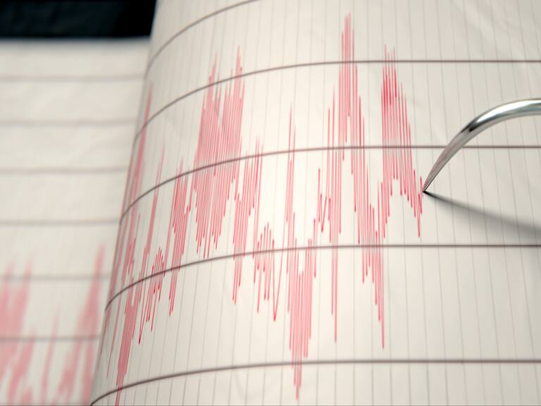 A closeup of a seismograph machine needle drawing a red line on graph paper depicting seismic and eartquake activity - 3D render