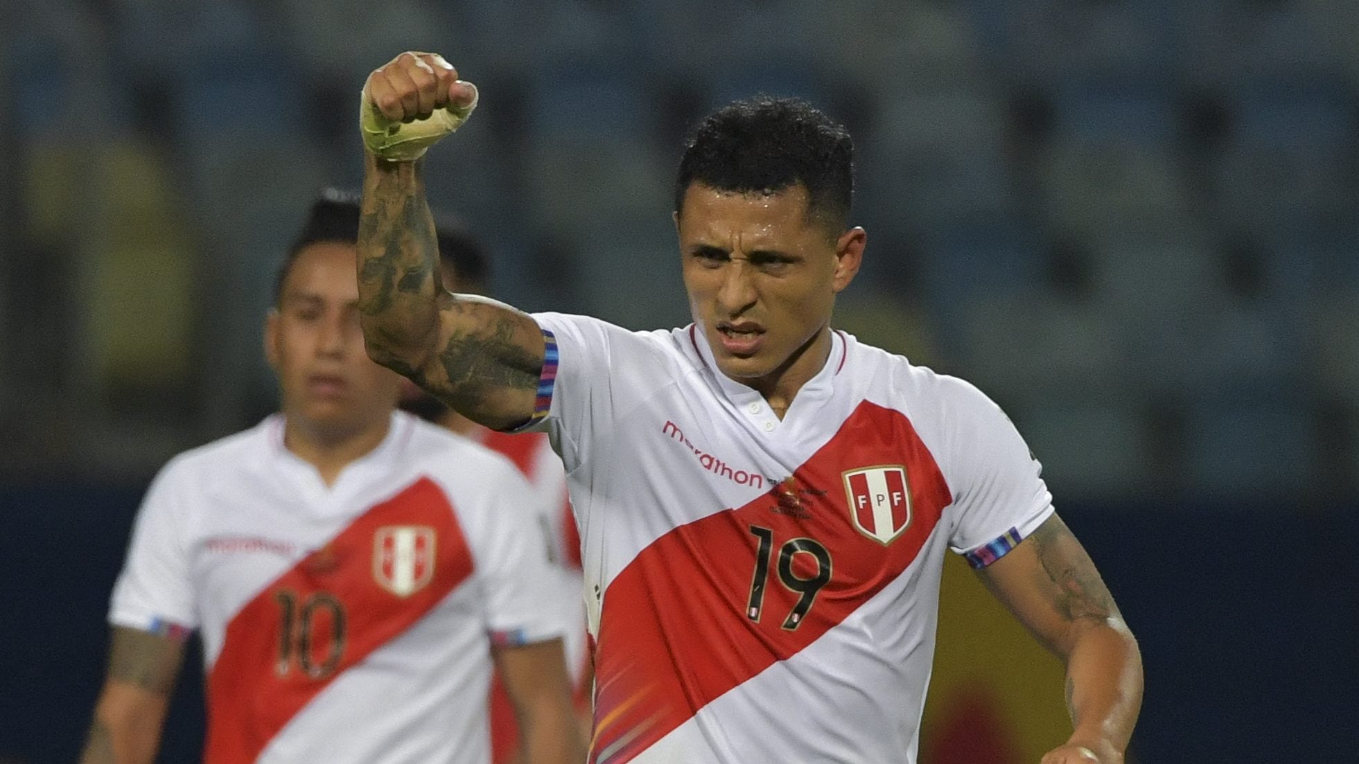 Peru's Yoshimar Yotun (R) celebrates next to teammate Christian Cueva after scoring against Paraguay during their Conmebol 2021 Copa America football tournament quarter-final match at the Olympic Stadium in Goiania, Brazil, on July 2, 2021. (Photo by NELSON ALMEIDA / AFP) (Photo by NELSON ALMEIDA/AFP via Getty Images)
