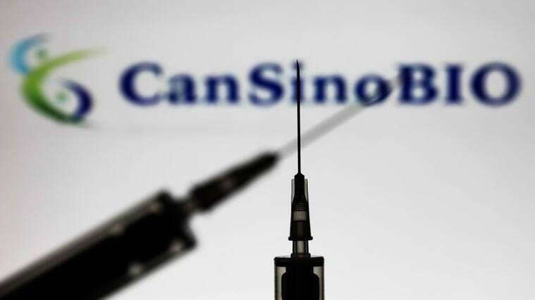 Medical syringes are seen with CanSino Biologics company logo displayed on a screen in the background in this illustration photo taken in Poland on November 15, 2020. (Photo by Jakub Porzycki/NurPhoto via Getty Images)