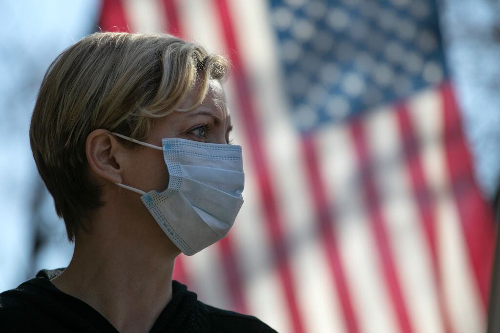 NEW ROCHELLE, NY - MARCH 18: Coronavirus crisis volunteer Rhiannon Navin greets local residents arriving to a food distribution center at the WestCop community center on March 18, 2020 in New Rochelle, New York. New Rochelle has been a hot spot for the COVID-19 pandemic in the U.S. (Photo by John Moore/Getty Images)