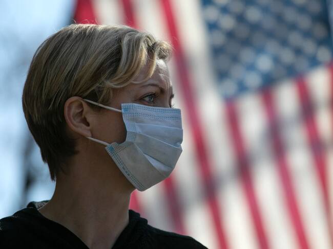 NEW ROCHELLE, NY - MARCH 18: Coronavirus crisis volunteer Rhiannon Navin greets local residents arriving to a food distribution center at the WestCop community center on March 18, 2020 in New Rochelle, New York. New Rochelle has been a hot spot for the COVID-19 pandemic in the U.S. (Photo by John Moore/Getty Images)