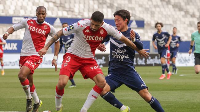 Monaco's Chilean defender Guillermo Maripan (2nd L) fights for the ball against Bordeaux's South Korean forward Hwang Ui-Jo during the French L1 football match between Girondins de Bordeaux and Monaco at the Matmut-Atlantique stadium in Bordeaux, southwestern France on April 18, 2021. (Photo by thibaud moritz / MORITZ / AFP) (Photo by THIBAUD MORITZ/MORITZ/AFP via Getty Images)