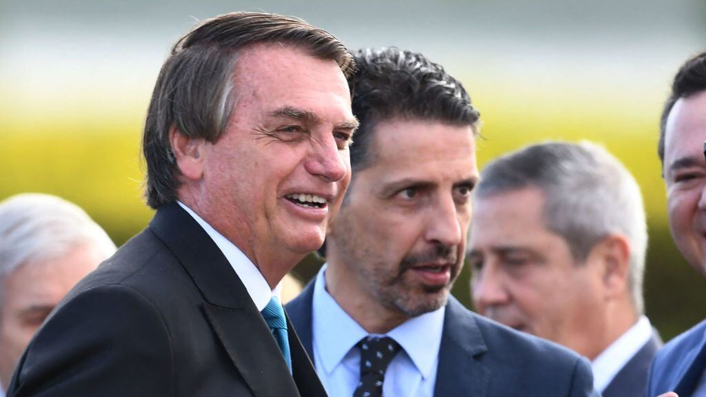 Brazilian President Jair Bolsonaro (L) and his Environment Minister Joaquim Leite (R) are seen during a flag-raising ceremony before the ministerial meeting at the Alvorada Palace in Brasilia, on March 17, 2022. - The level of activity of the Brazilian economy started the year 2022 in a decline, according to information released today by the Central Bank. (Photo by EVARISTO SA / AFP) (Photo by EVARISTO SA/AFP via Getty Images)