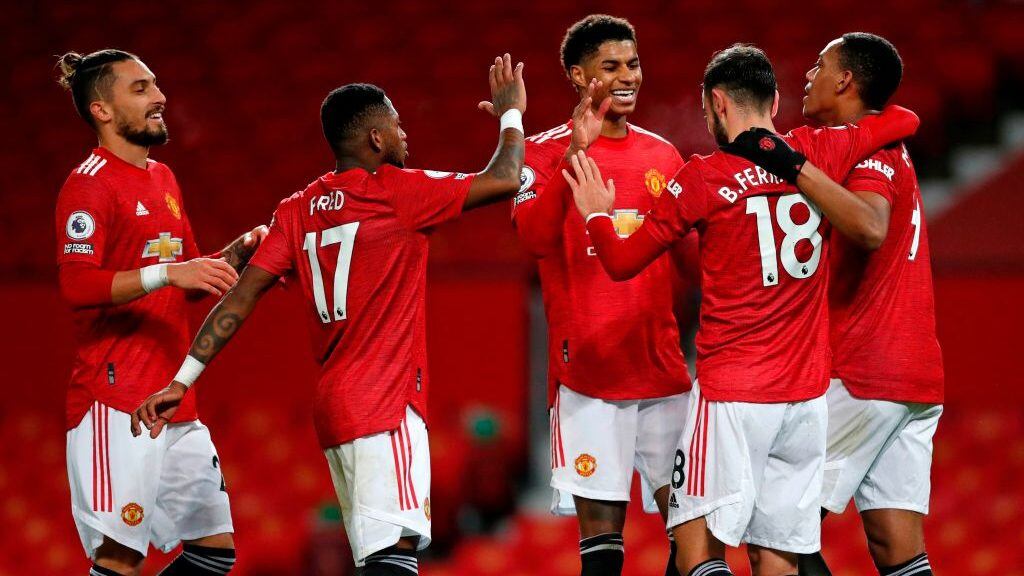 Manchester United's Portuguese midfielder Bruno Fernandes (2nd R) celebrates with teammates after scoring their sixth goal from the penalty spot during the English Premier League football match between Manchester United and Leeds United at Old Trafford in Manchester, north west England, on December 20, 2020. (Photo by Clive Brunskill / POOL / AFP) / RESTRICTED TO EDITORIAL USE. No use with unauthorized audio, video, data, fixture lists, club/league logos or 'live' services. Online in-match use limited to 120 images. An additional 40 images may be used in extra time. No video emulation. Social media in-match use limited to 120 images. An additional 40 images may be used in extra time. No use in betting publications, games or single club/league/player publications. / (Photo by CLIVE BRUNSKILL/POOL/AFP via Getty Images)