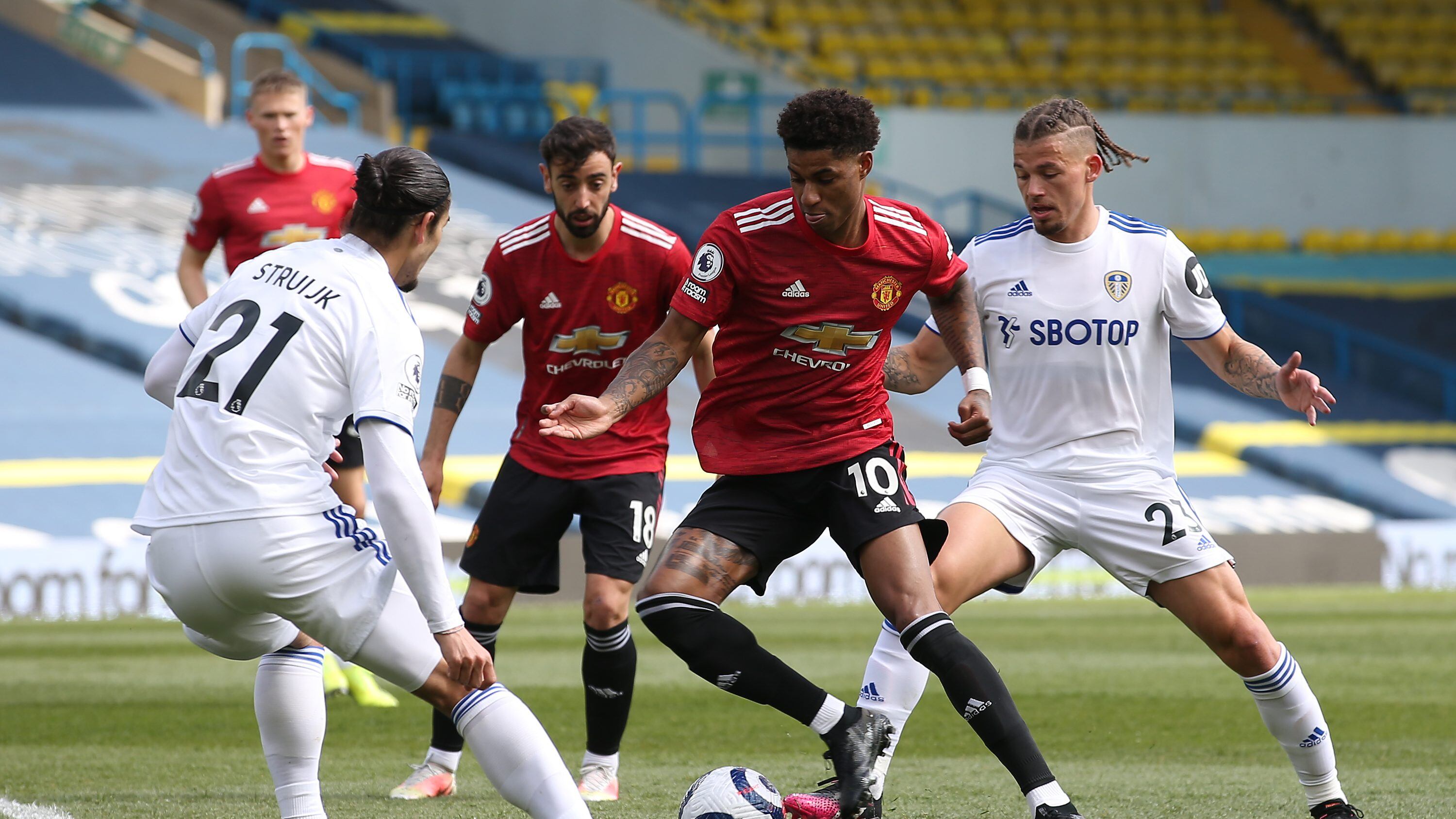 LEEDS, ENGLAND - APRIL 25: Marcus Rashford of Manchester United in action with Pascal Struijk and Kalvin Phillips of Leeds United during the Premier League match between Leeds United and Manchester United at Elland Road on April 25, 2021 in Leeds, England. Sporting stadiums around the UK remain under strict restrictions due to the Coronavirus Pandemic as Government social distancing laws prohibit fans inside venues resulting in games being played behind closed doors. (Photo by Matthew Peters/Manchester United via Getty Images)
