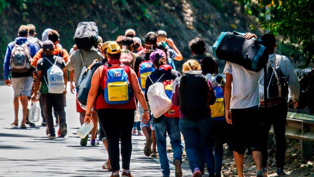 Venezuelan migrants walk along a highway in Cucuta, Colombia, on the border with Venezuela, on February 2, 2021, amid the COVID-19 pandemic. (Photo by Schneyder MENDOZA / AFP) (Photo by SCHNEYDER MENDOZA/AFP via Getty Images)