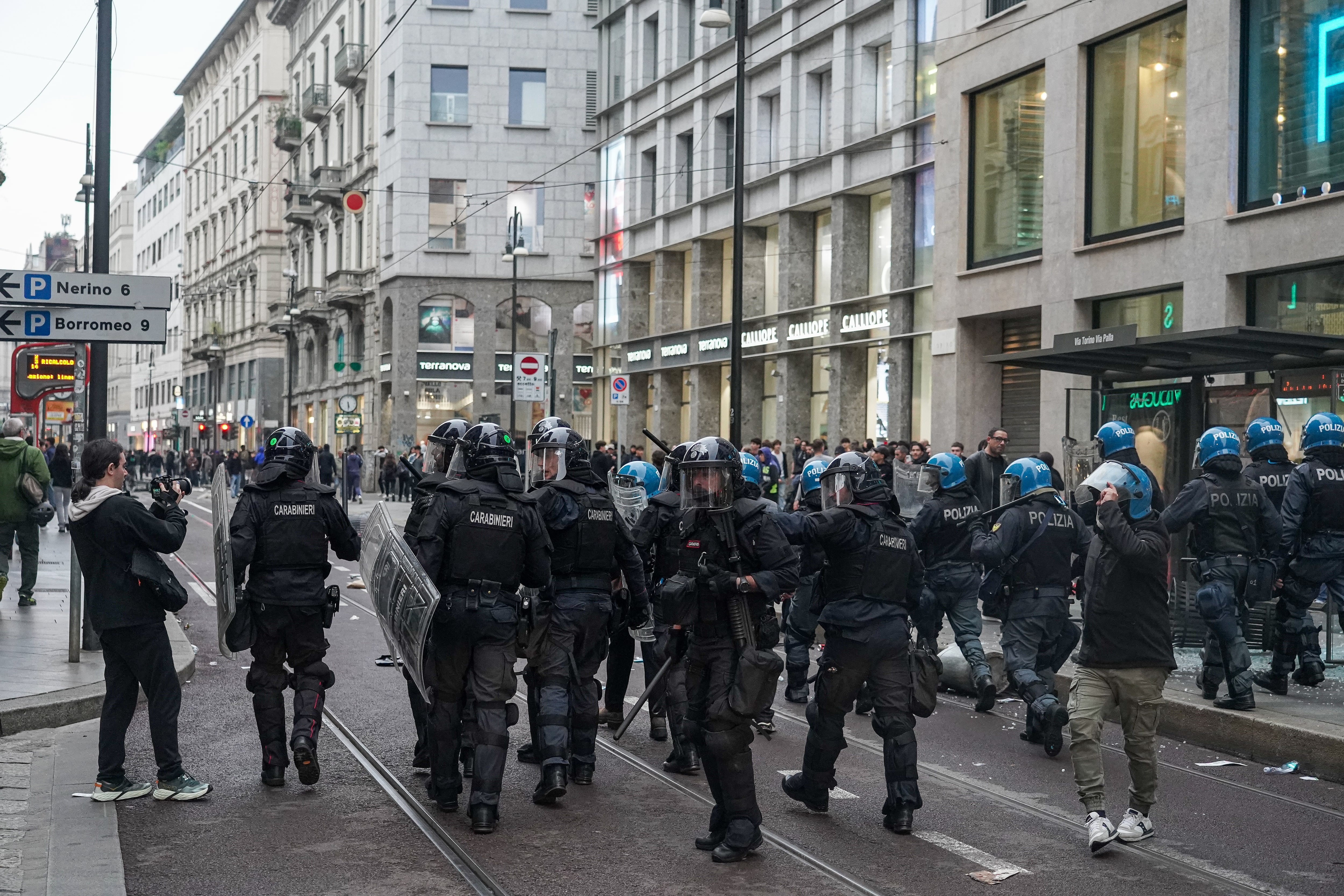 Police and hooded youths clash in the streets of Milan's city center, Italy, on October 18, 2026, following incidents of vandalism and looting. (Photo by Emanuele Roberto De Carli/NurPhoto via Getty Images)