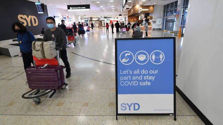 SYDNEY, AUSTRALIA - NOVEMBER 28: Passengers arrive at Sydney International Airport on November 28, 2021 in Sydney, Australia. NSW Health authorities will now send people who have been overseas in the two weeks before their arrival into three days of home quarantine, as the state works out its response to the threat posed by a new, “concerning” variant of COVID-19 named Omicron. Premier Dominic Perrottet says precautionary steps are needed to protect against the Omicron variant while experts investigate the risk to the public. The border control, announced on Saturday evening, is on top of new restrictions imposed by the federal government on Saturday, closing the border to nine countries in Southern Africa. Australian citizens entering NSW who have been in South Africa, Lesotho, Botswana, Zimbabwe, Mozambique, Namibia, Eswatini, Malawi, and the Seychelles in the last two weeks must now do two weeks of mandatory hotel quarantine. (Photo by James D. Morgan/Getty Images)