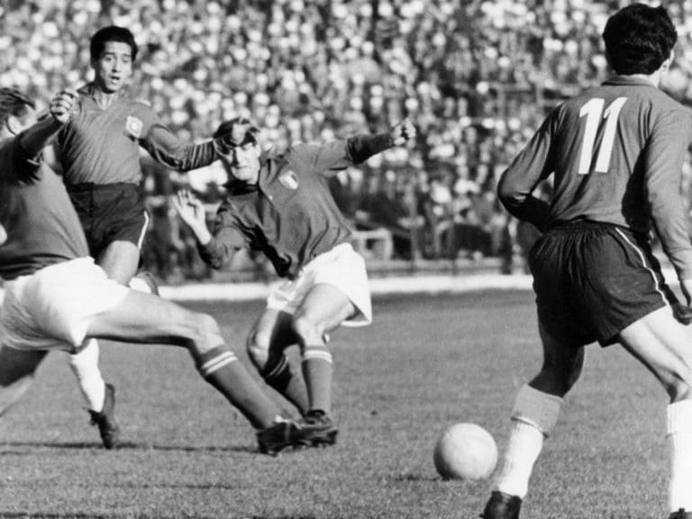 Italian defender David (L) tries to reach the ball and lunges forward while Chilean forward Leonel Sanchez (R, no 11) looks on during the 1962 World Cup group game Chile against Italy at the National Stadium in Santiago de Chile, Chile, 2 June 1962. Chile won the game 2-0 in front of 66,000 spectators. The game was considered to be a scandal due to a continues series of fouls and assaults on the pitch which disrupted the game. Davis and Sanchez clashed repeatedly during the game. Two Italian players were sent off whereby one player only left when police officers escorted him off the pitch. (Photo by -/picture alliance via Getty Images)