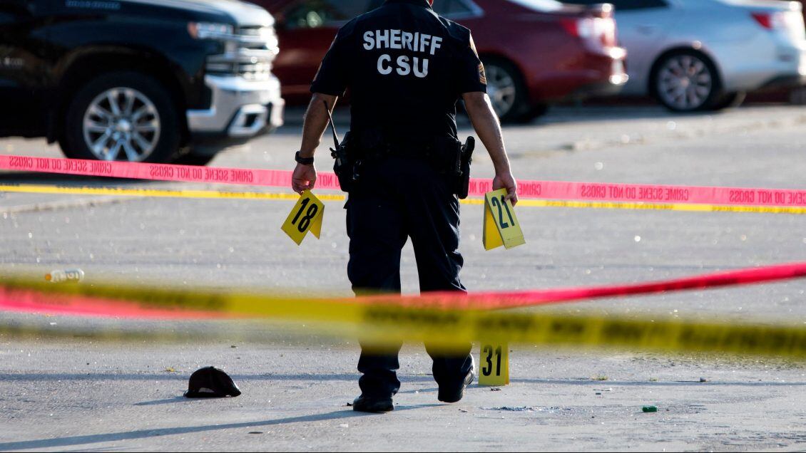 A police officer investigates a crime scene where two people were killed and three more critically injured in a shooting at a flea market in Houston, Texas on May 15, 2022. - Two people were killed and three more were taken to a hospital with injuries after a shooting May 15, 2022 at a bustling Houston flea market, authorities said. The shooting at the open-air market arose from an "altercation" that involved at least two guns and all five of the people, according to Harris County Sheriff Ed Gonzalez. He said no "innocent bystanders" were injured. (Photo by Mark Felix / AFP) (Photo by MARK FELIX/AFP /AFP via Getty Images)