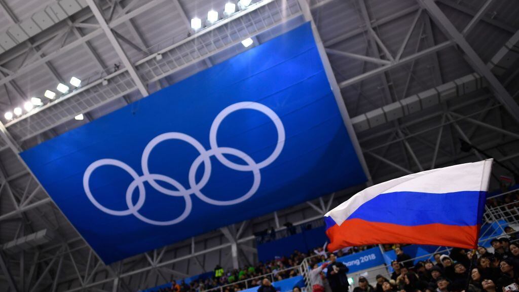 A spectator waves the Russia flag during the men's preliminary round ice hockey match between the Olympic Athletes from Russia and Slovenia during the Pyeongchang 2018 Winter Olympic Games at the Gangneung Hockey Centre in Gangneung on February 16, 2018. / AFP PHOTO / Brendan Smialowski (Photo credit should read BRENDAN SMIALOWSKI/AFP via Getty Images)