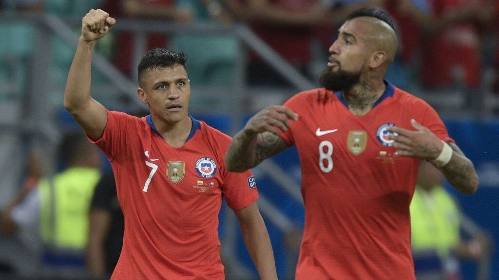 Chile's Alexis Sanchez (L) celebrates near teammate Arturo Vidal after scoring against Ecuador during their Copa America football tournament group match at the Fonte Nova Arena in Salvador, Brazil, on June 21, 2019. (Photo by Juan MABROMATA / AFP) (Photo credit should read JUAN MABROMATA/AFP via Getty Images)
