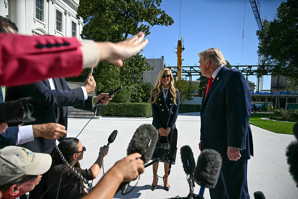 US President Donald Trump and newly appointed White House Press Secretary Katie Zacharia talk to members of the press before boarding Marine One as he departs from the South Lawn of the White House in Washington, DC, on October 13, 2026. President Trump is traveling to Wasilla, Alaska to hold a campaign rally ahead of the midterm elections. (Photo by Jim WATSON / AFP via Getty Images)