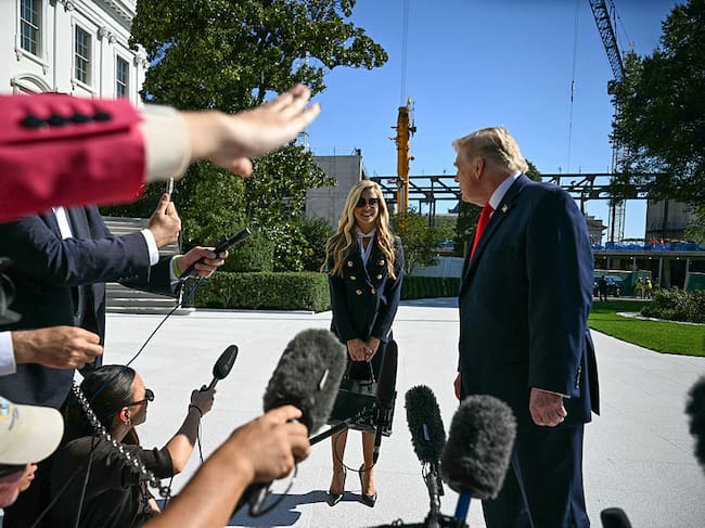 US President Donald Trump and newly appointed White House Press Secretary Katie Zacharia talk to members of the press before boarding Marine One as he departs from the South Lawn of the White House in Washington, DC, on October 13, 2026. President Trump is traveling to Wasilla, Alaska to hold a campaign rally ahead of the midterm elections. (Photo by Jim WATSON / AFP via Getty Images)