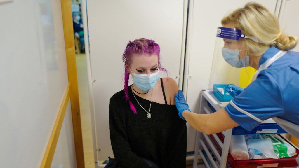 TRURO, ENGLAND - DECEMBER 09: Erin Lilly becomes the first person in Cornwall to receive their Covid-19 vaccination as the Royal Cornwall Hospital began their vaccination programme on December 9, 2020 in Truro, United Kingdom. More than 50 hospitals across England were designated as covid-19 vaccine hubs, the first stage of what will be a lengthy vaccination campaign. NHS staff, over-80s, and care home residents will be among the first to receive the Pfizer/BioNTech vaccine, which recently received emergency approval from the country's health authorities. (Photo by Hugh Hastings/Getty Images)