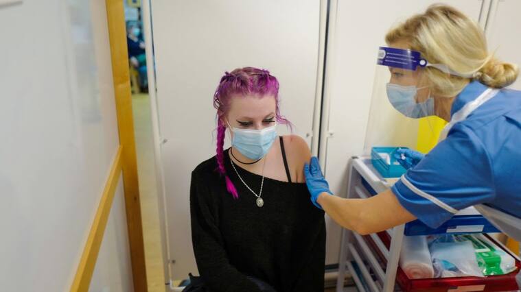TRURO, ENGLAND - DECEMBER 09: Erin Lilly becomes the first person in Cornwall to receive their Covid-19 vaccination as the Royal Cornwall Hospital began their vaccination programme on December 9, 2020 in Truro, United Kingdom. More than 50 hospitals across England were designated as covid-19 vaccine hubs, the first stage of what will be a lengthy vaccination campaign. NHS staff, over-80s, and care home residents will be among the first to receive the Pfizer/BioNTech vaccine, which recently received emergency approval from the country's health authorities. (Photo by Hugh Hastings/Getty Images)