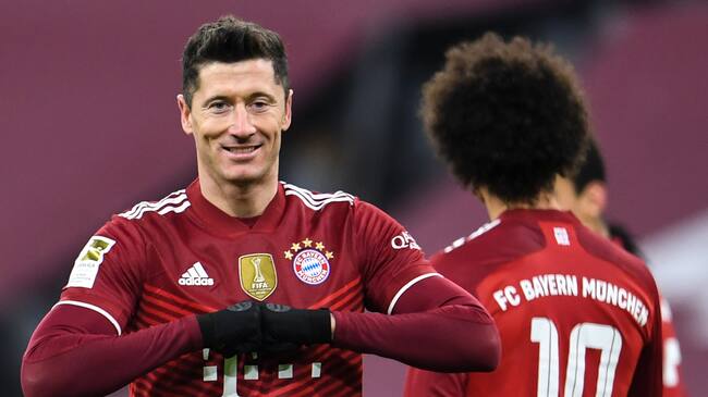17 December 2021, Bavaria, Munich: Football: Bundesliga, Bayern Munich - VfL Wolfsburg, Matchday 17, at Allianz Arena. Munich's Robert Lewandowski celebrates his goal to make it 4:0. (RECROP) IMPORTANT NOTE: In accordance with the regulations of the DFL Deutsche Fußball Liga and the DFB Deutscher Fußball-Bund, it is prohibited to use or have used photographs taken in the stadium and/or of the match in the form of sequence pictures and/or video-like photo series. Photo: Tobias Hase/dpa (Photo by Tobias Hase/picture alliance via Getty Images)