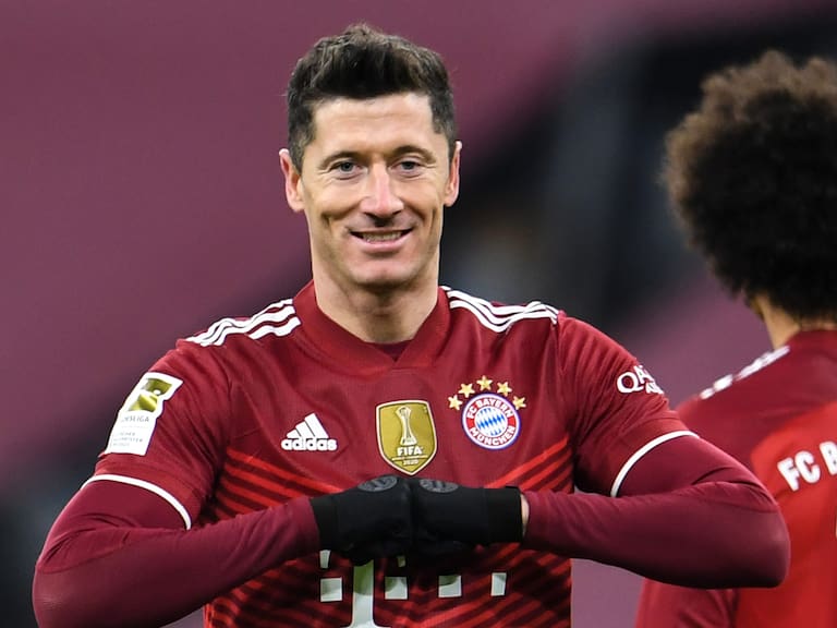 17 December 2021, Bavaria, Munich: Football: Bundesliga, Bayern Munich - VfL Wolfsburg, Matchday 17, at Allianz Arena. Munich's Robert Lewandowski celebrates his goal to make it 4:0. (RECROP) IMPORTANT NOTE: In accordance with the regulations of the DFL Deutsche Fußball Liga and the DFB Deutscher Fußball-Bund, it is prohibited to use or have used photographs taken in the stadium and/or of the match in the form of sequence pictures and/or video-like photo series. Photo: Tobias Hase/dpa (Photo by Tobias Hase/picture alliance via Getty Images)