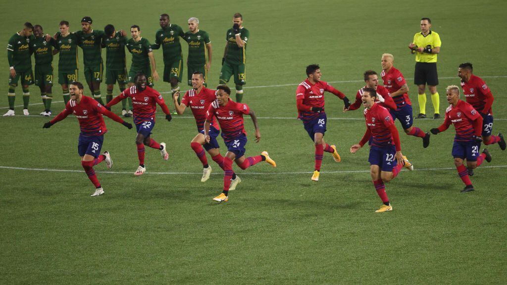 PORTLAND, OREGON - NOVEMBER 22: FC Dallas players celebrate after defeating the Portland Timbers on penalties during Round One of the MLS Cup Playoffs at Providence Park on November 22, 2020 in Portland, Oregon. (Photo by Abbie Parr/Getty Images)