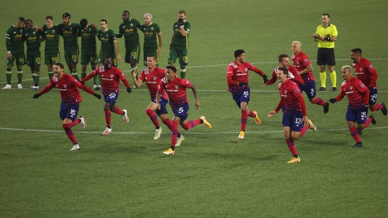 PORTLAND, OREGON - NOVEMBER 22: FC Dallas players celebrate after defeating the Portland Timbers on penalties during Round One of the MLS Cup Playoffs at Providence Park on November 22, 2020 in Portland, Oregon. (Photo by Abbie Parr/Getty Images)