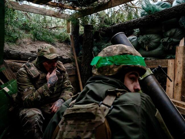 Dos soldados del Ejército de Ucrania se protegen al interior de una trinchera en la región de Donetsk.