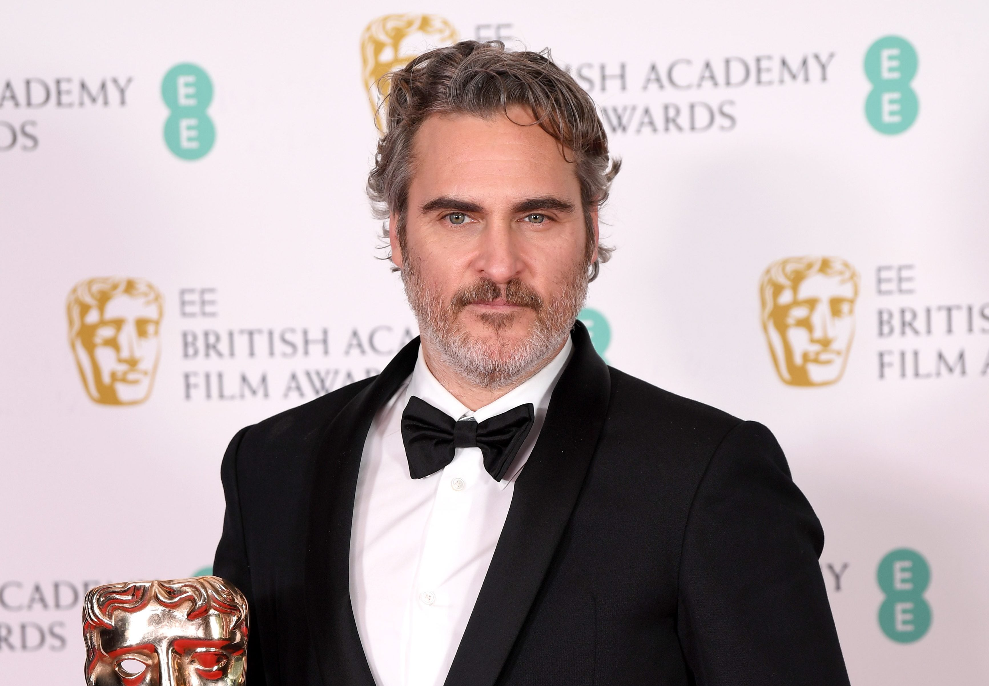 LONDON, ENGLAND - FEBRUARY 02: Joaquin Phoenix with his Best Actor award for "The Joker' poses in the Winners Room during the EE British Academy Film Awards 2020 at Royal Albert Hall on February 02, 2020 in London, England. (Photo by Karwai Tang/WireImage)