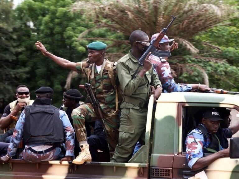 Malian soldiers drive through the streets of Bamako, Mali on August 19, 2020, the day after rebel troops seized Malian President Ibrahim Boubacar Keita and Prime Minister Boubou Cisse in a dramatic escalation of a months-long crisis. - Mali awoke on August 19, 2020, to a new chapter in its troubled history after rebel military leaders forced Malian President Boubacar Keita from office, prompting its West African neighbours to threaten border closures and sanctions against the coup leaders.Keita, embattled by months of protests over economic stagnation, corruption and a brutal Islamist insurgency, said he had resigned to avoid bloodshed. (Photo by ANNIE RISEMBERG / AFP) (Photo by ANNIE RISEMBERG/AFP via Getty Images)