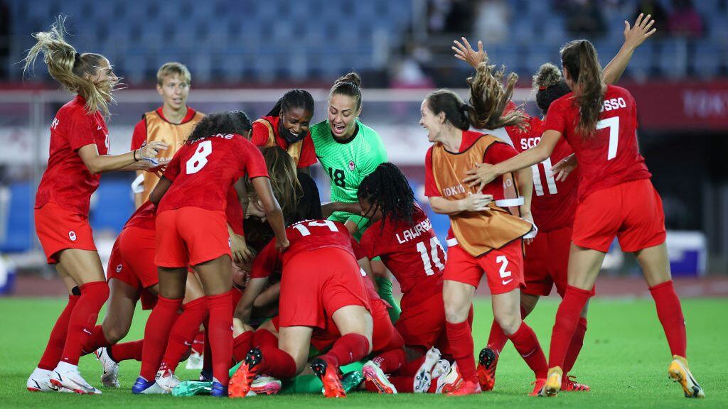 RIFU, MIYAGI, JAPAN - JULY 30: Stephanie Labbe #1 of Team Canada celebrates victory with teammates after saving the Team Brazil fifth penalty taken by Rafaelle #4 (Not pictured) in a penalty shoot out during the Women's Quarter Final match between Canada and Brazil on day seven of the Tokyo 2020 Olympic Games at Miyagi Stadium on July 30, 2021 in Rifu, Miyagi, Japan. (Photo by Koki Nagahama/Getty Images)