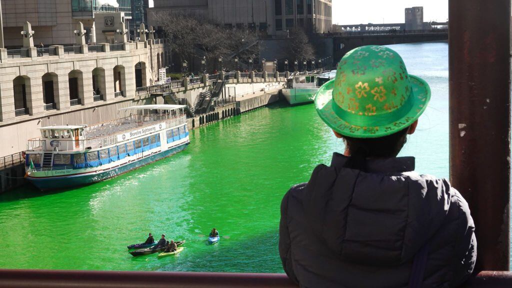 CHICAGO, ILLINOIS - MARCH 13: People view the Chicago River after it was dyed green in celebration of St. Patrick's Day on March 13, 2021 in Chicago, Illinois. The dyeing of the river, a St. Patrick's Day tradition in the city, was cancelled last year due to the COVID-19 pandemic. It was reported to be cancelled this year but the city approved a last-minute early-morning clandestine dyeing to keep the usual spectators at bay. (Photo by Scott Olson/Getty Images)
