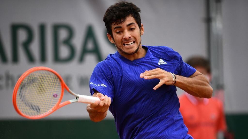 Chile's Christian Garin returns the ball to Marcos Giron of the US during their men's singles third round tennis match on Day 6 of The Roland Garros 2021 French Open tennis tournament in Paris on June 4, 2021. (Photo by Christophe ARCHAMBAULT / AFP) (Photo by CHRISTOPHE ARCHAMBAULT/AFP via Getty Images)