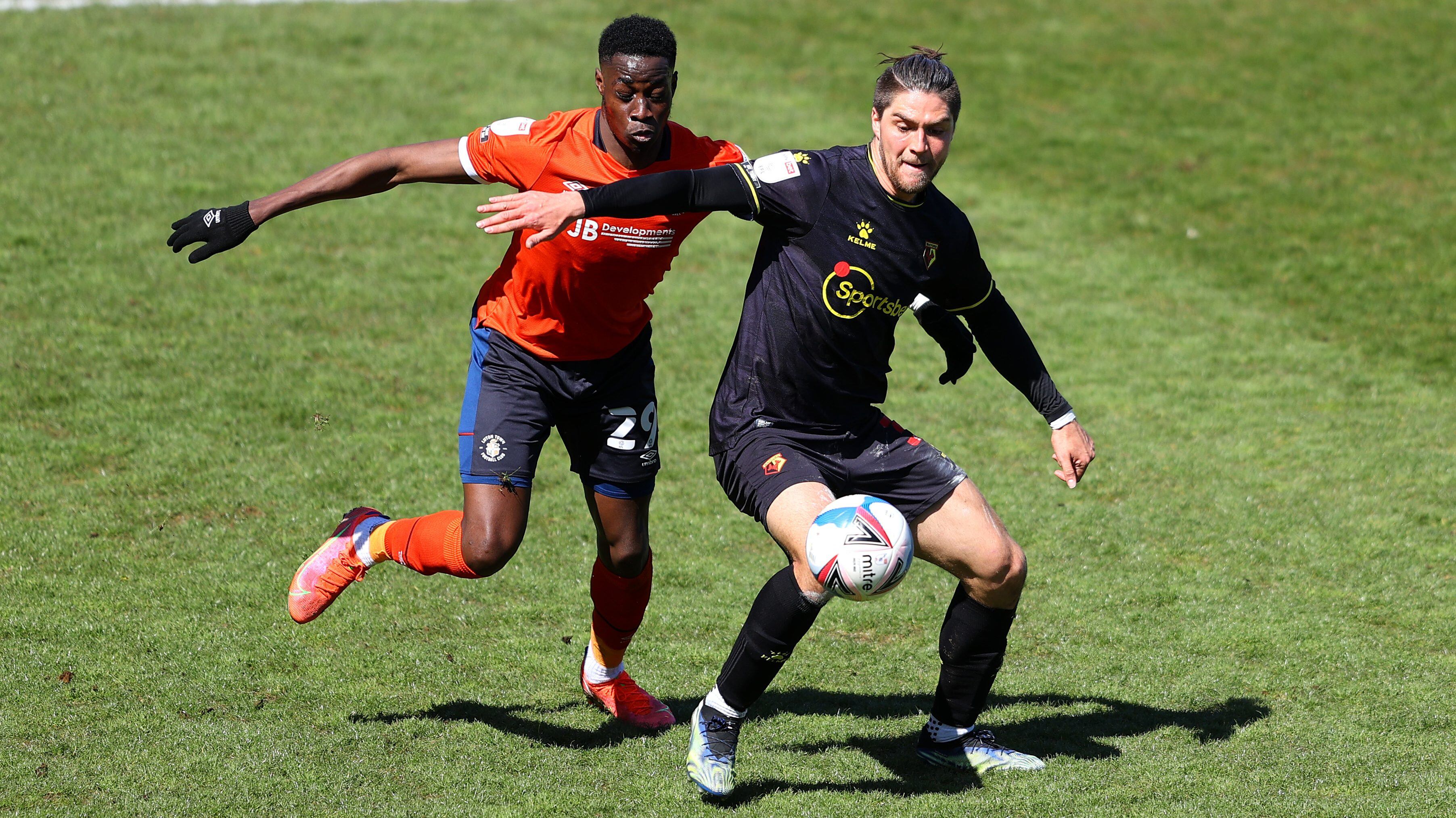 LUTON, ENGLAND - APRIL 17: Francisco Sierralta of Watford FC battles for possession with Elijah Adebayo of Luton Town during the Sky Bet Championship match between Luton Town and Watford at Kenilworth Road on April 17, 2021 in Luton, England. Sporting stadiums around the UK remain under strict restrictions due to the Coronavirus Pandemic as Government social distancing laws prohibit fans inside venues resulting in games being played behind closed doors. (Photo by Richard Heathcote/Getty Images)