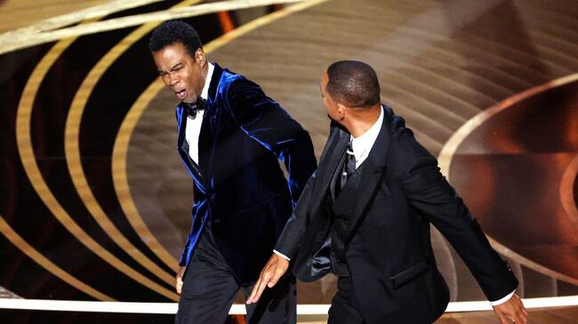HOLLYWOOD, CA - March 27, 2022. Will Smith slaps Chris Rock onstage during the show at the 94th Academy Awards at the Dolby Theatre at Ovation Hollywood on Sunday, March 27, 2022. (Myung Chun / Los Angeles Times via Getty Images)