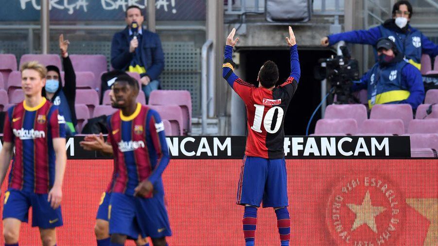 BARCELONA, SPAIN - NOVEMBER 29: Lionel Messi of Barcelona celebrates after scoring their sides fourth goal while wearing a Newell's Old Boys shirt with the number 10 on the back in memory of former footballer, Diego Maradona, who recently passed away during the La Liga Santander match between FC Barcelona and C.A. Osasuna at Camp Nou on November 29, 2020 in Barcelona, Spain. Sporting stadiums around Spain remain under strict restrictions due to the Coronavirus Pandemic as Government social distancing laws prohibit fans inside venues resulting in games being played behind closed doors. (Photo by David Ramos/Getty Images)